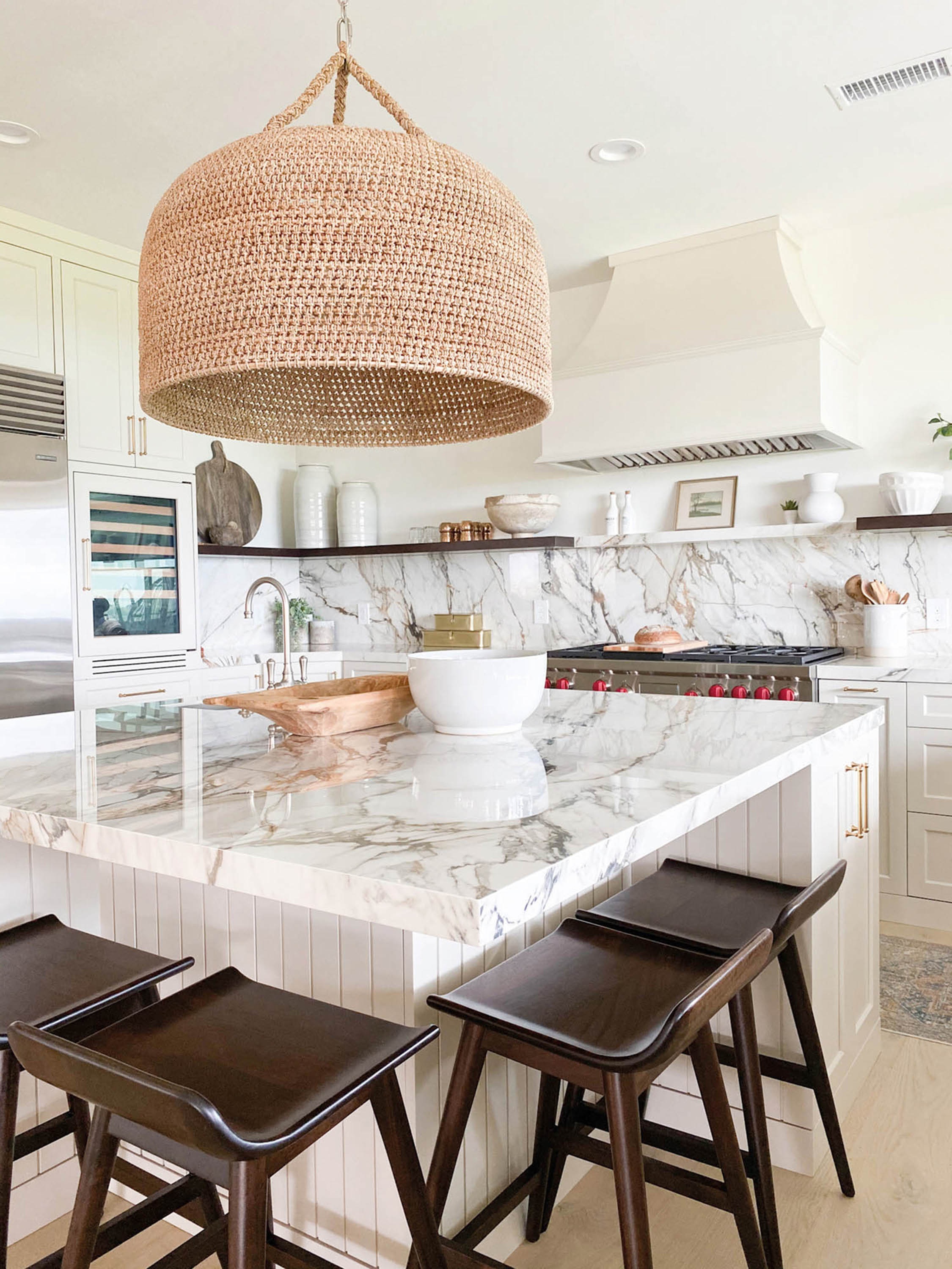 Installed kitchen with a stone island and marble backsplash